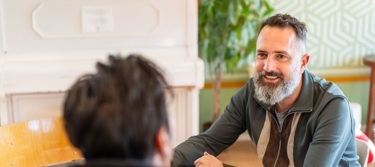 Locatiemanager Menno Schot in gesprek met bewoner azc