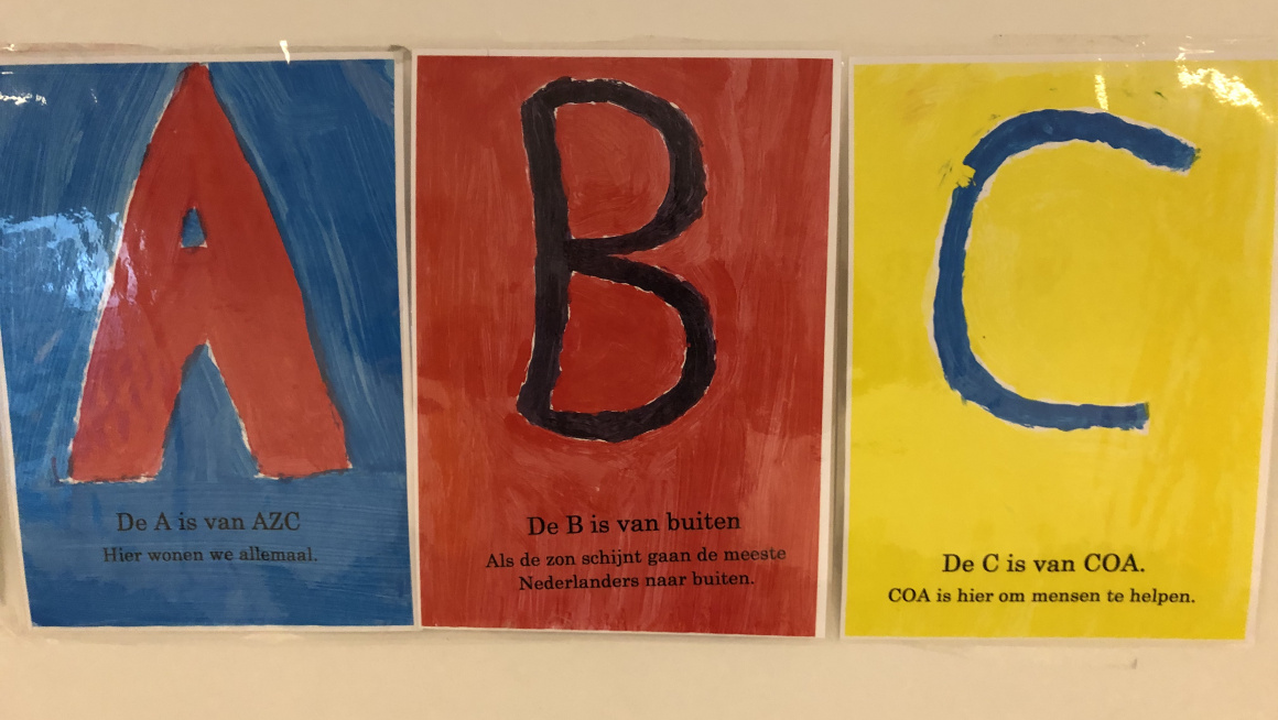 3 posters op de muur: een rode A op blauwe achtergrond, een zwarte B op een rode achtergrond en een blauwe C met gele achtergrond